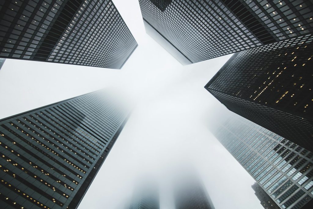 Glass office towers viewed from below representing commercial property