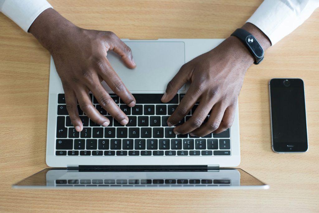 Hands typing on a laptop representing starting a no win no fee claim