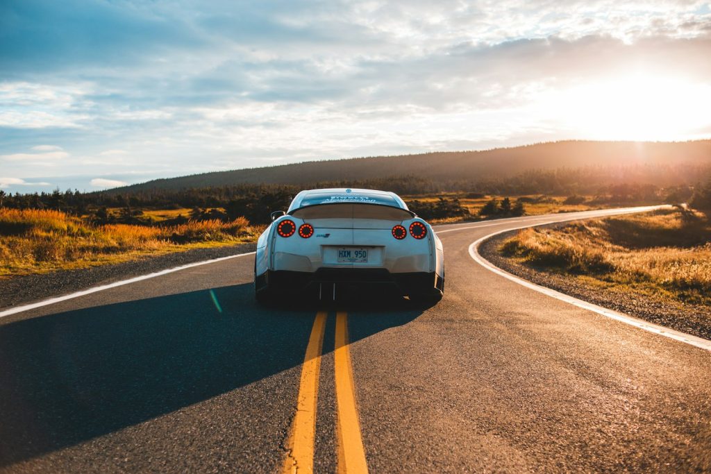 Car travelling on an open road representing foreign vehicle injury claims