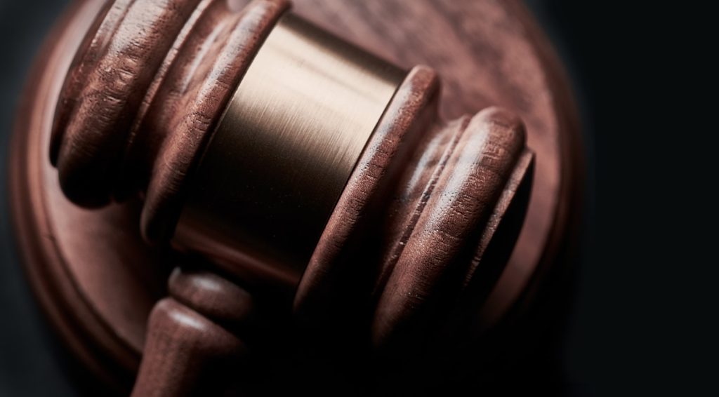 Wooden gavel and sound block representing defending a contested will