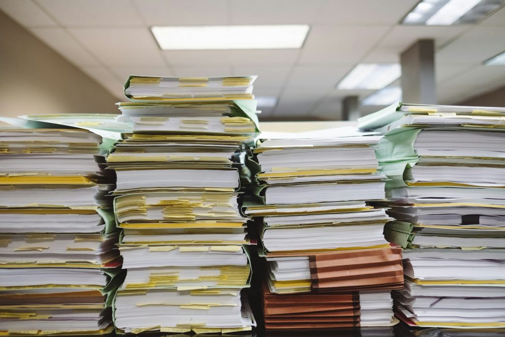 Stacks of case files and documents representing statutory will disputes