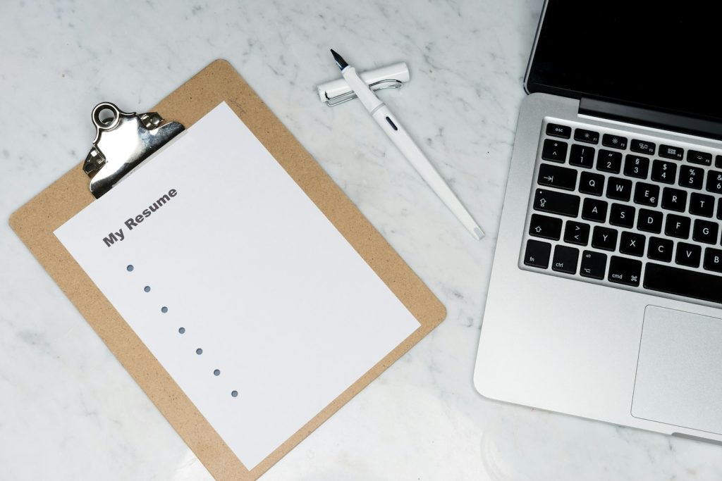 Clipboard, pen and laptop representing reviewing and transferring a claim