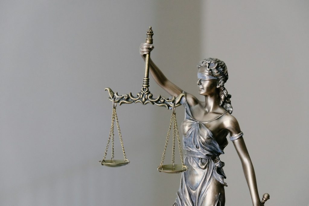 Statue of the scales of justice representing claims against the police