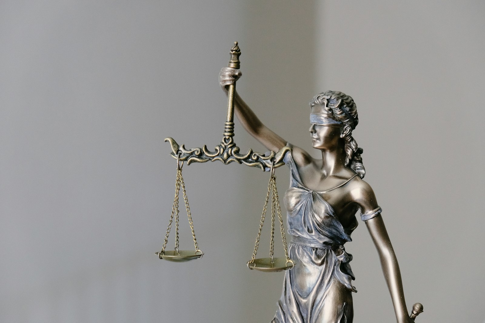 Statue of the scales of justice representing claims against the police